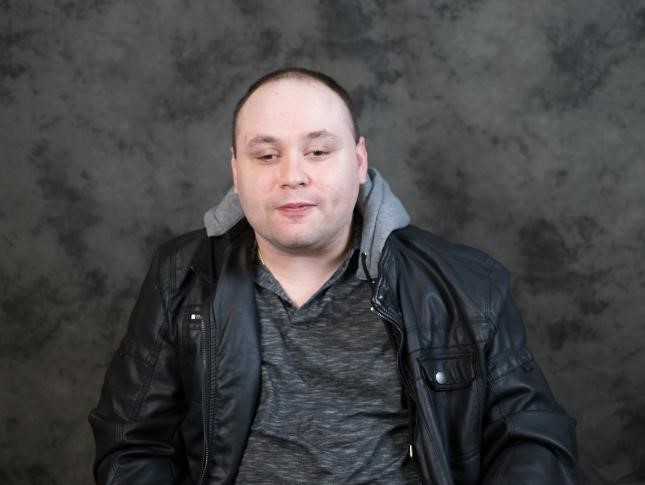 Headshot of Mat Rice, white man smiling into the camera, with a grey background