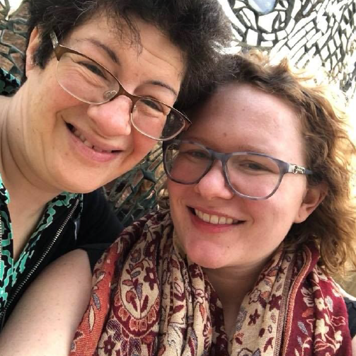 Liz Weintraub and Jalyn Marks are smiling at the camera. Their faces are
close together for the selfie. Liz is a middle-aged white woman with an intellectual disability,
wearing glasses and short hair. Jalyn is in her twenties, wears glasses, and has light brown hair.
She identifies as having an invisible disability.