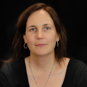 image description: picture of Rylin Rodgers, a white woman with dark brown hair wearing a black shirt in front of a black background